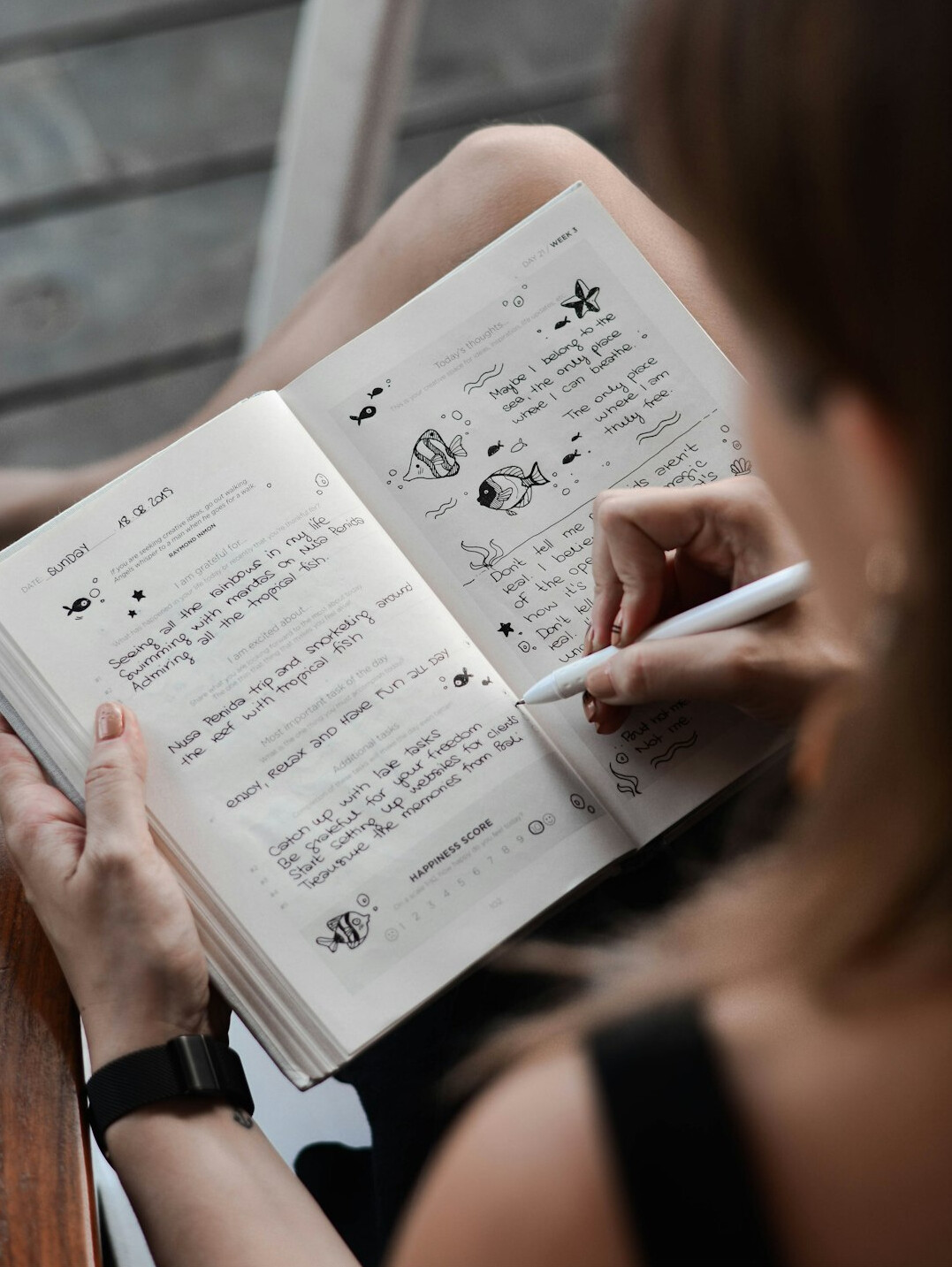 person setting goals on notebook